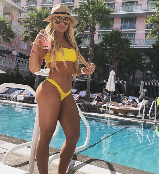 Mandy Rose shared a picture of her posing in a yellow bikini by the pool and captioned it, 