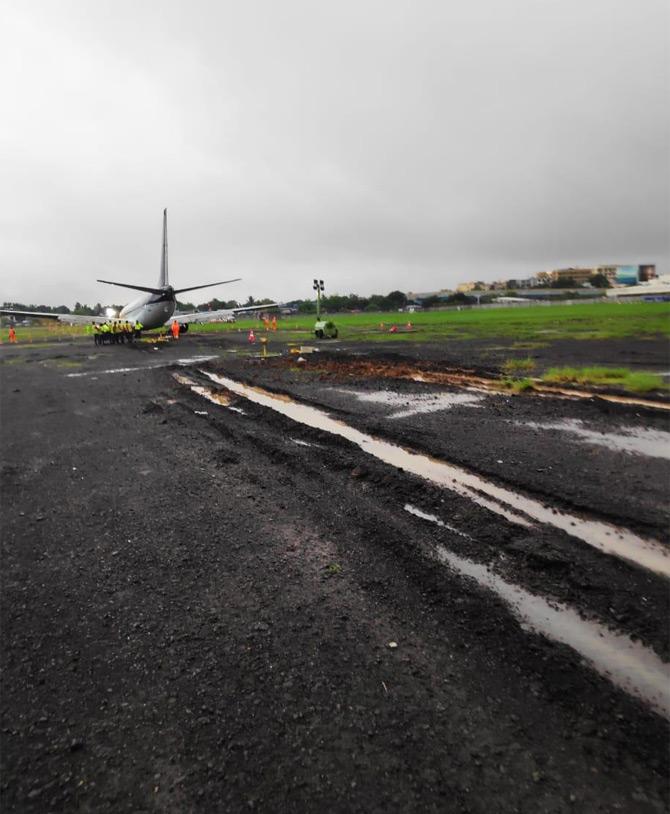 In pic: SpiceJet plane overshoots the runaway as engineers take a look at the plane for any kind of damage.