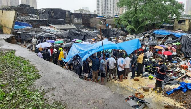 According to officials, the compound wall of a school in Pimpripada in Malad suburb collapsed on some adjoining hutments in which more than 13 people were killed, around 1 am on Tuesday. Pic/Satej Shinde