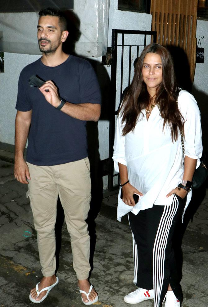 Neha Dhupia and Angad Bedi were out enjoying dinner with few friends at a restaurant in Bandra. Angad wore a blue tee and Khaki pants, while Neha wore a white tee and black track pants.