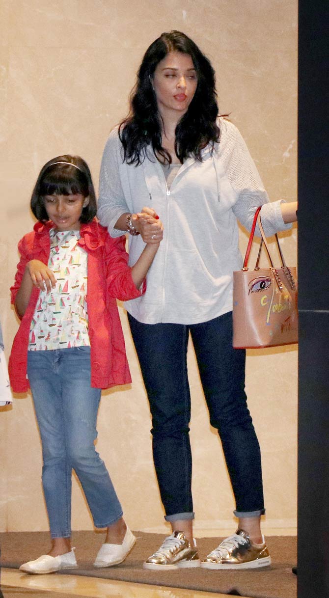 Aishwarya Rai Bachchan, Aaradhya Bachchan, Abhishek Bachchan and Vrinda Rai were snapped at a popular restaurant in Bandra, Mumbai. The actress was seen wearing a basic shirt, paired with denim pants and golden sneakers. All pictures/Yogen Shah