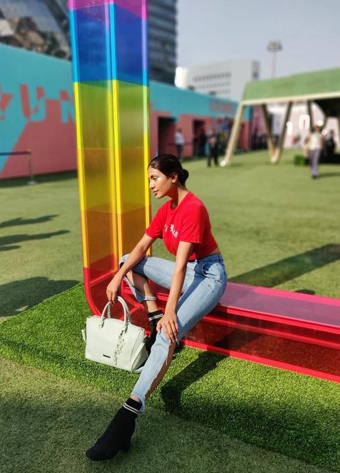 Urvi Shetty shared a leaf out of her modelling days as she is seen attending the Lakme Fashion Week. In the picture, Urvi Shetty sports a tough look as she dons a red crop top and pairs it with blue denim jeans.