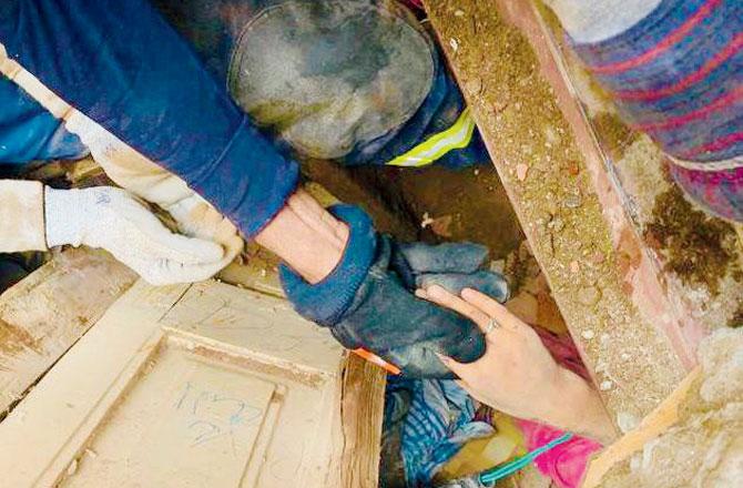 Fire brigade officials had to cut through iron beams, spread the wooden planks and remove debris using hydraulic cutters, spreader and power tools, to rescue Zeenat Salmani alive