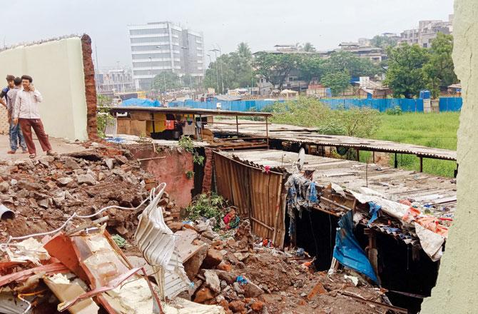 The wall that collapsed on the hutments