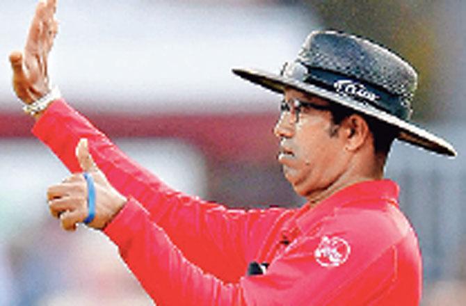 Umpire Kumar Dharmasena signals six runs during Sunday