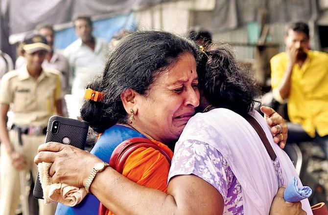 Staff members weep in relief after being rescued from the inferno at the MTNL building in Bandra West on Monday afternoon. Pic/Pradeep Dhivar 