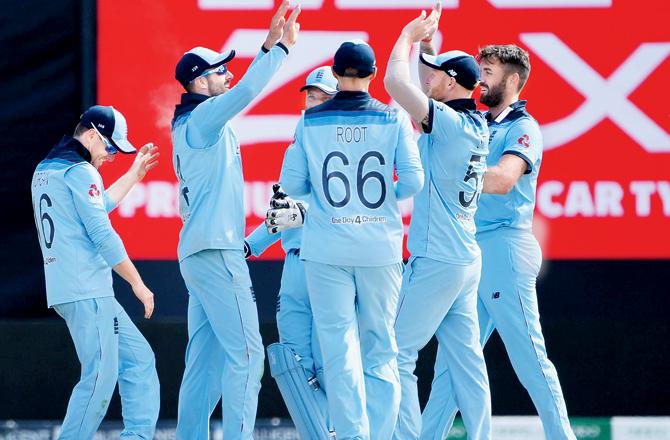 England players celebrate the dismissal of India captain Virat Kohli at Edgbaston yesterday. Pic/AFP
