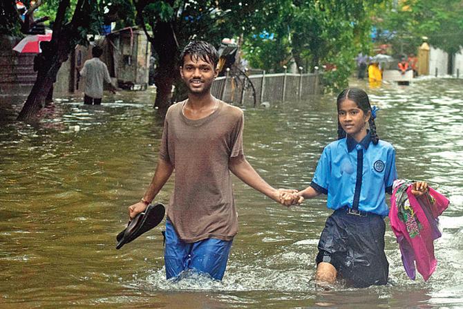 Two children wade through the flooded street at Gandhi Market. PICS/ASHISH RAJE