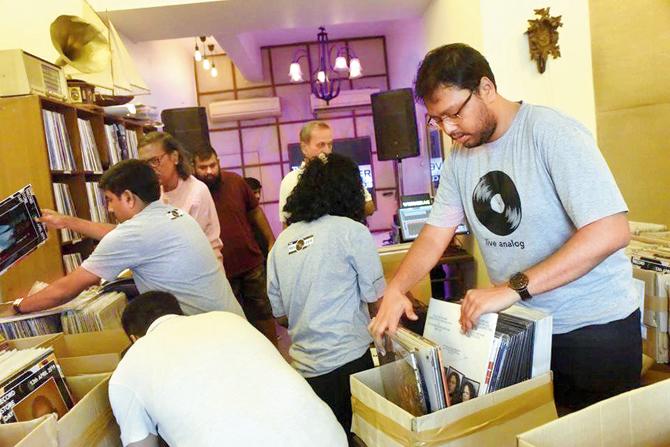 partner Shalom Benjamin sifts through records during a meet-up