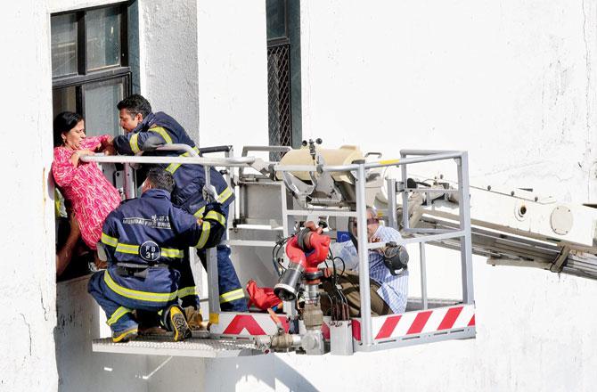 Fire Brigade personnel rescue a trapped woman