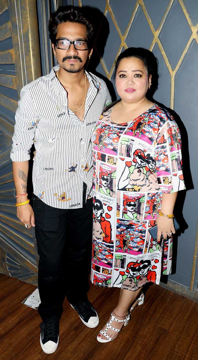 Bharti Singh and husband Haarsh Limbachiyaa posed for the photographers at Mika Singh's birthday party at a popular pub in Andheri.