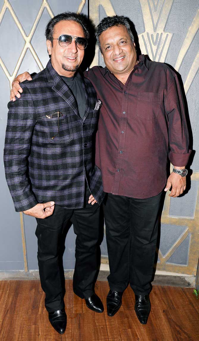 Bollywood's 'badman' Gulshan Grover and director Sanjay Gupta posed for the photographers at Mika Singh's birthday party in Andheri.