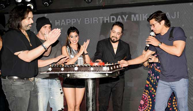 Singer Mika Singh's grand birthday party was attended by a host of Bollywood and television celebs at a popular pub in Andheri, Mumbai. Mika has been in showbiz for more than 20 years and has given many hit songs like Subha Hone Na De and Aaj Ki Party among others. All pictures/Yogen Shah
In picture: Mika Singh cuts his birthday cake with Shaan, Sohail Khan and others on stage.
