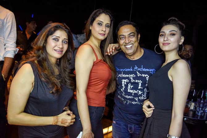 Vindu Dara Singh and friends pose for the photographers at Mika Singh's birthday bash.