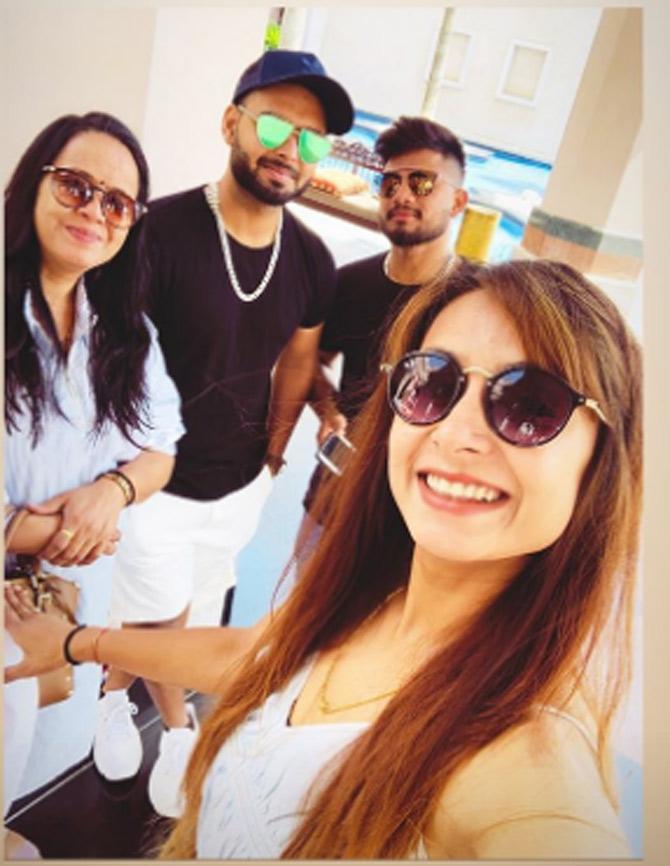 Rishabh Pant looks cool here in a black t-shirt and white shorts with a pair of trendy sunglasses. Sakshi Pant posted this picture while en route for lunch at a posh restaurant.