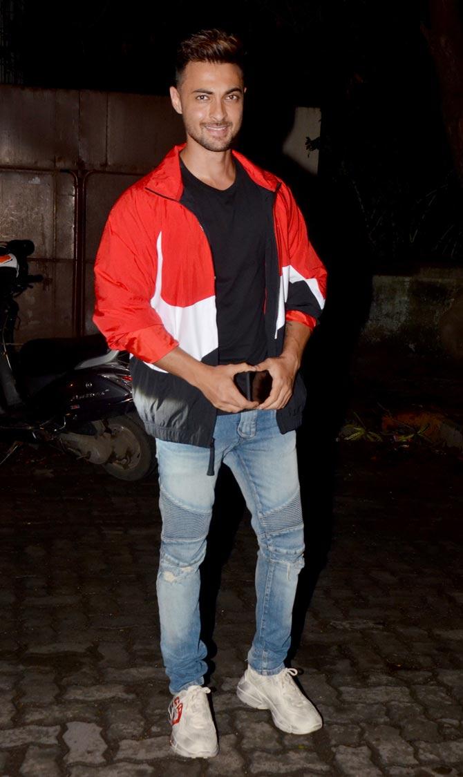 Aayush Sharma opted for a red and white bomber jacket, paired with a basic black tee and denim when clicked at Rohini Iyer's house party hosted in Mumbai. 