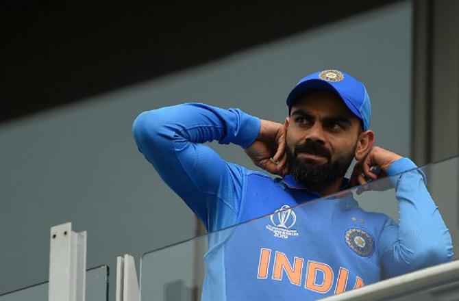 India's captain Virat Kohli looks on from a balcony during the 2019 Cricket World Cup group stage match between India and Pakistan at Old Trafford in Manchester, northwest England, on June 16, 2019. 