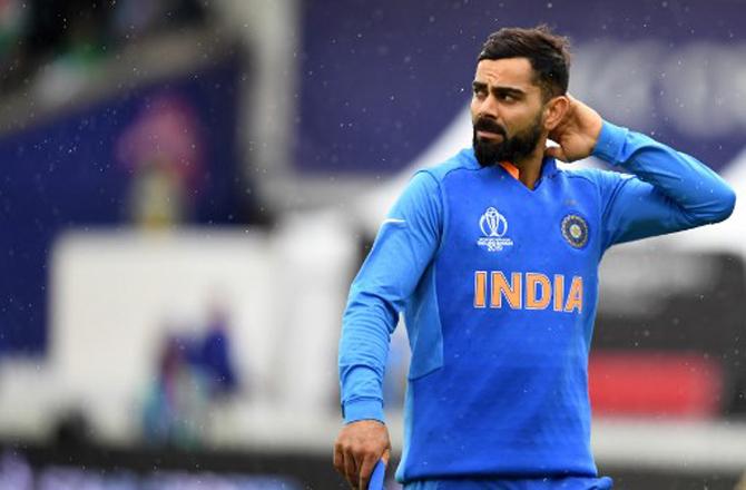 Virat Kohli in this picture looks miffed with the rain. The rain, however, thankfully did not make much of an impact in the match.