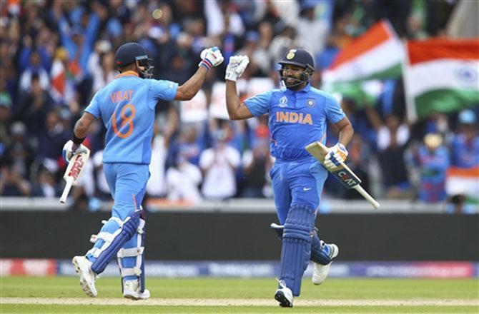 Rohit Sharma and Virat Kohli here celebrate the Mumbai Indians captain's century.