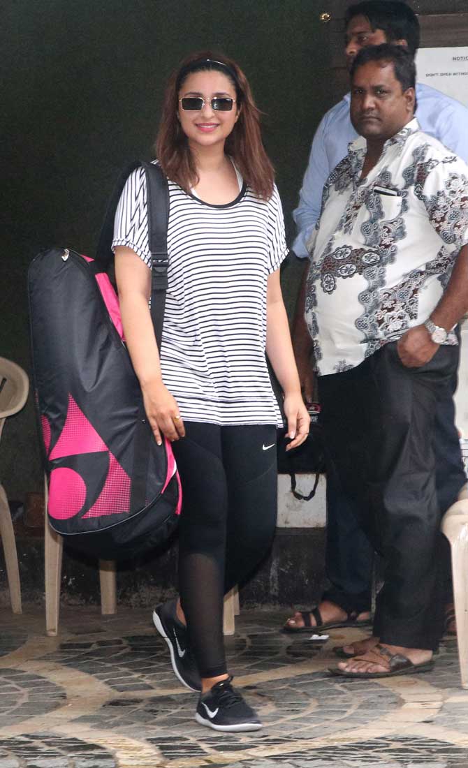 For her badminton session, the actress sported a checkered t-shirt, black leggings which she teamed up with regular black sports shoes.