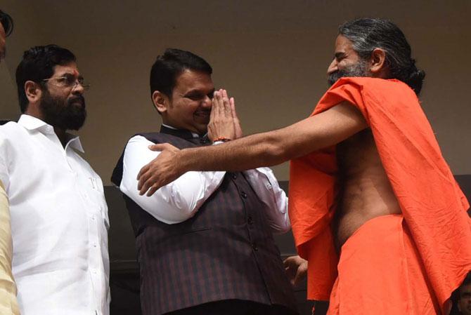 While Chief Minister Devendra Fadnavis greets yoga guru Ramdev with folded hands, the baba prefers a jaadu ki jhappi, taking the CM by surprise on the third day at the monsoon session of the Maharashtra Assembly. 
