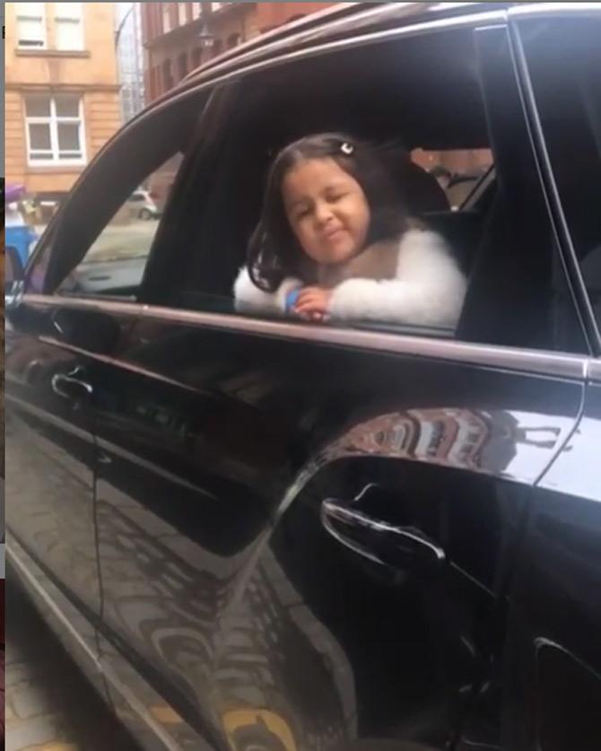 Ziva Dhoni is zip-zapping through the cities of England in luxury SUVs. Here she is seen working her wink.