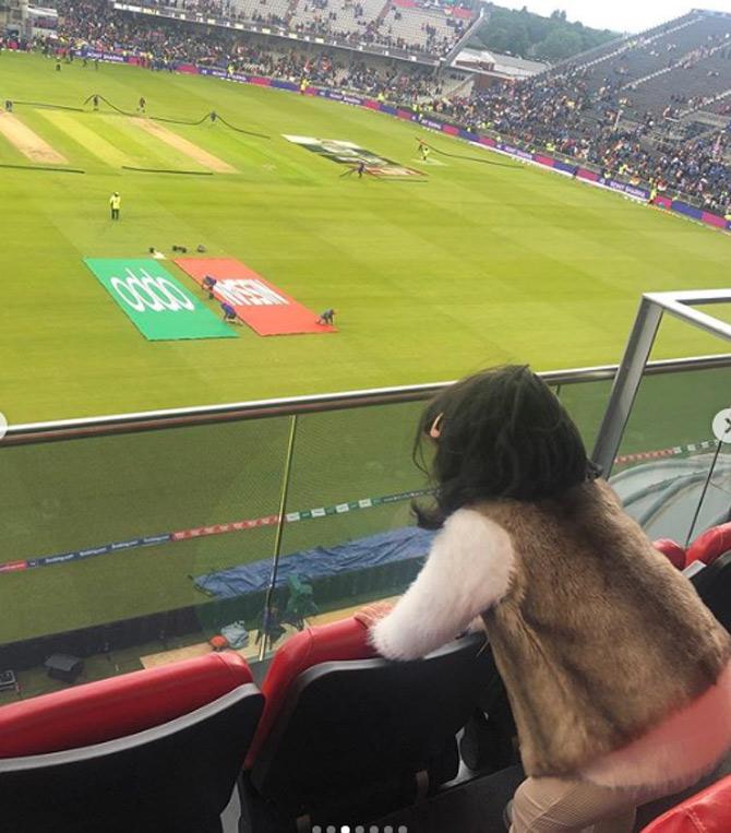 The rain looks to have dampened Ziva Dhoni's spirits. The little cutie is seen here looking on and waiting for the play to resume during India vs Pakistan match.