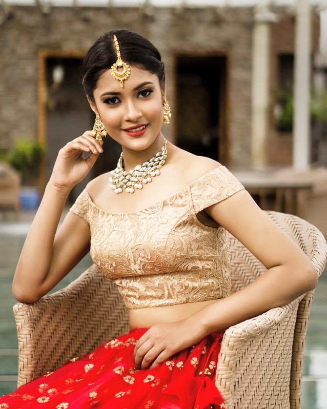 Jyotishmita Baruah makes for a stunning beauty in this red lehenga and golden blouse as she smiles for the camera
