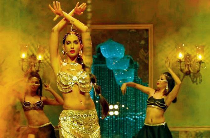 The original song from Sirf Tum - Dilbar - created a storm when it first released in 1999. The chartbuster now recreated for the film Satyameva Jayate became a bigger sensation. In the original, the song was picturised on Sushmita Sen and Sanjay Kapoor, while the remix has Nora Fatehi sizzling with her belly dance. The song has been recreated by Tanishk Bagchi and written by Shabbir Ahmed. It is sung by Neha Kakkar, Dhvani and Alka Yagnik whose voice has been kept from the original composition.