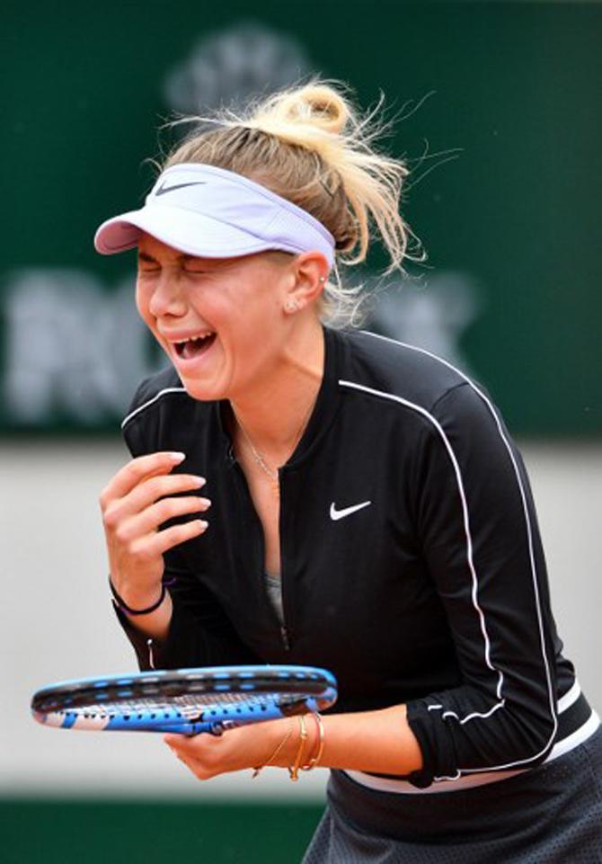 Amanda Anisimova of the US reacts during her women's singles semi-final match against Australia's Ashleigh Barty on day 13 of The Roland Garros 2019 French Open tennis tournament in Paris on June 7, 2019. 