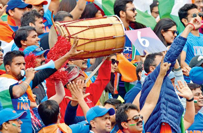 Indian supporters cheer their team during the group stage match against Pakistan at Old Trafford in Manchester on Sunday. Pic/Bipin Patel