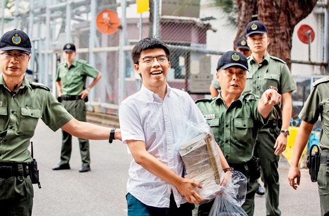 Joshua Wong (C) leaves Lai Chi Kok Correctional Institute in Hong Kong. Pic/AFP