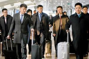 Believed to be North Korean negotiator Kim Hyok Chol (second from left) after arriving from Pyongyang. Pic/AFP