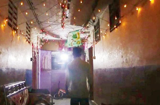 A grab from the UDRI film, Free Housing-Free TB, shows a dimly-lit passageway in one of the buildings at Lallubhai Compound