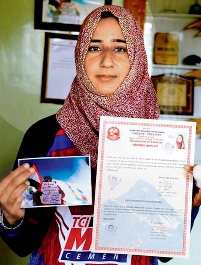 She poses with her certificate