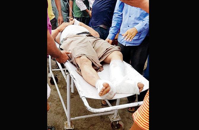 Rescuers carrying an injured victim. Pics/PTI/ANI Twitter