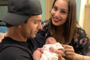 Karan Singh Grover and Bipasha posing with a baby leaves fans confused