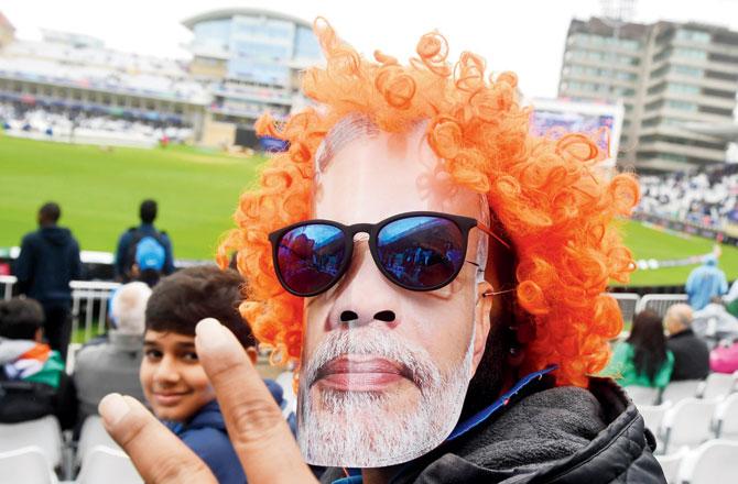 An Indian fan wears a PM Narendra Modi mask in Nottingham on Thursday