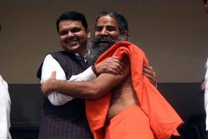 Devendra Fadnavis greets Baba Ramdev, gets a hug in return