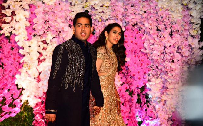 There were fireworks and an aerial act at the glitzy celebration night in Mumbai on Sunday for newly-weds Akash Ambani and Shloka Mehta. Akash, son of Reliance Industries Chairman and Managing Director Mukesh Ambani, and Shloka, youngest daughter of diamond merchant Russell Mehta, beamed with joy as they posed for shutterbugs against a heavily decorated floral backdrop. While Akash looked smart in a black kurta with a long embellished jacket, Shloka wore a golden ensemble