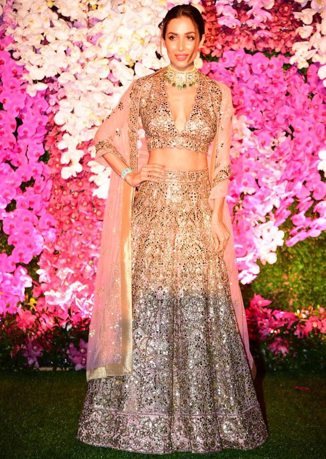 Fashionista Malaika Arora attended the glitzy celebration in honour of newly-weds Akash Ambani and Shloka Mehta in a glamourous lehenga