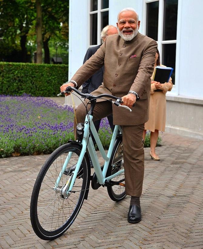 Narendra Modi riding a bicycle in the Netherlands. The Prime Minister of Netherlands gifted him the bicycle. 