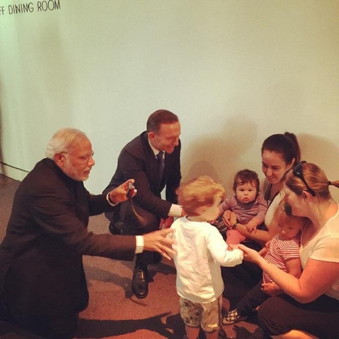 Narendra Modi in a candid moment with the locals in Australia and also clicked pictures along with Australian Prime Minister.