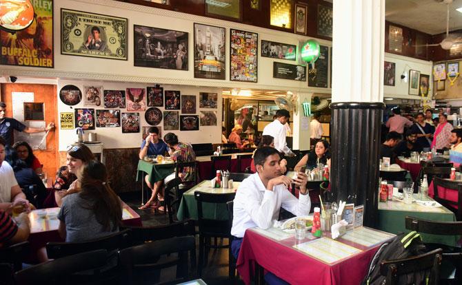 With high ceilings, the tinted glass windows, some of them even shattered - come rain, sun or war, Leopold Cafe has survived it all.