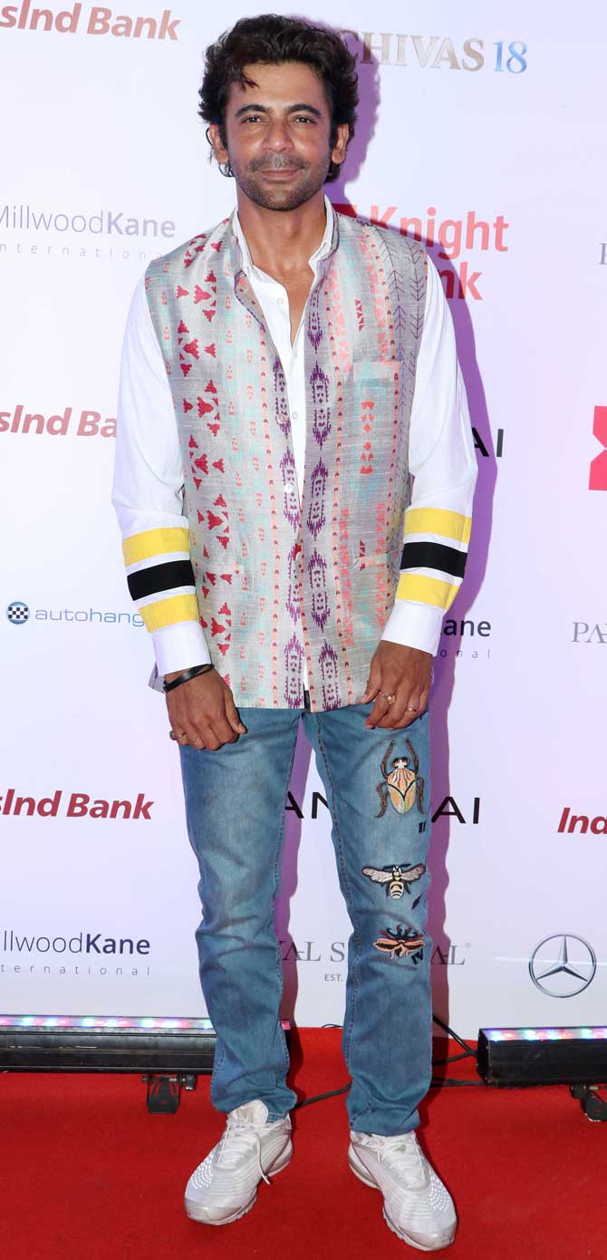 Sunil Grover also attended the fashion show held at a plush hotel in Bandra, Mumbai. The actor was seen donning a printed shirt, paired with patched basic blue denim and white sneakers. 