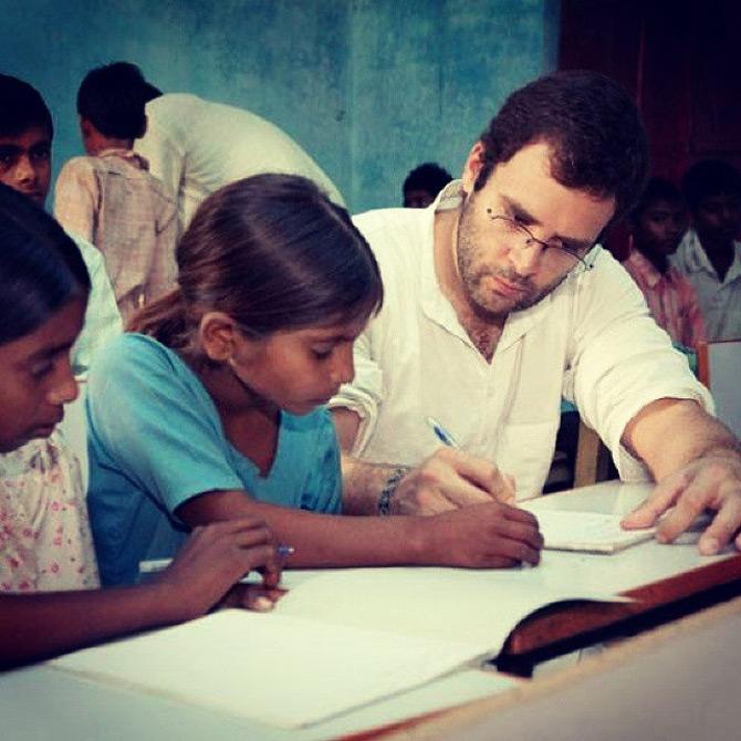 From walking with children during his rallies to interacting with them and answering their queries, Rahul Gandhi has been there and done it all.
In pic: Rahul Gandhi looks intrigued as he teaches small children how to write while emphasising importance on education.