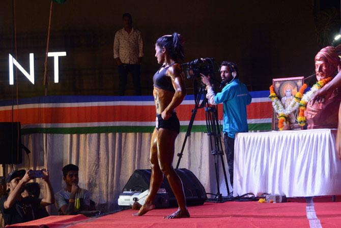 Female bodybuilder flaunts her muscles in front of the judges during the Mumbai Bodybuilding competition 'Mumbai Shree 2019', organised by Maharashtra Navnirman Sena (MNS) at Vithaldas Nagar, Khar in Mumbai on Sunday. 