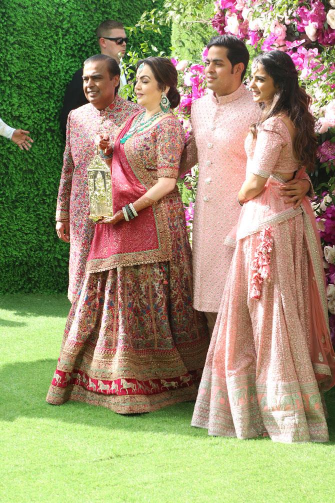 In photo: Akash Ambani is all smiles for the camera as he poses with parents Mukesh and Nita and sister Isha during his wedding at BKC.




