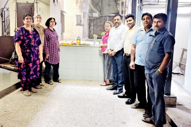 Residents from Karim Manzil, Singapuri and Sukhadwala buildings stand by the well in Karim Manzil