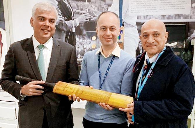 Rahul Mankad (right) and Sunil Hansraj present the bat to MCC museum